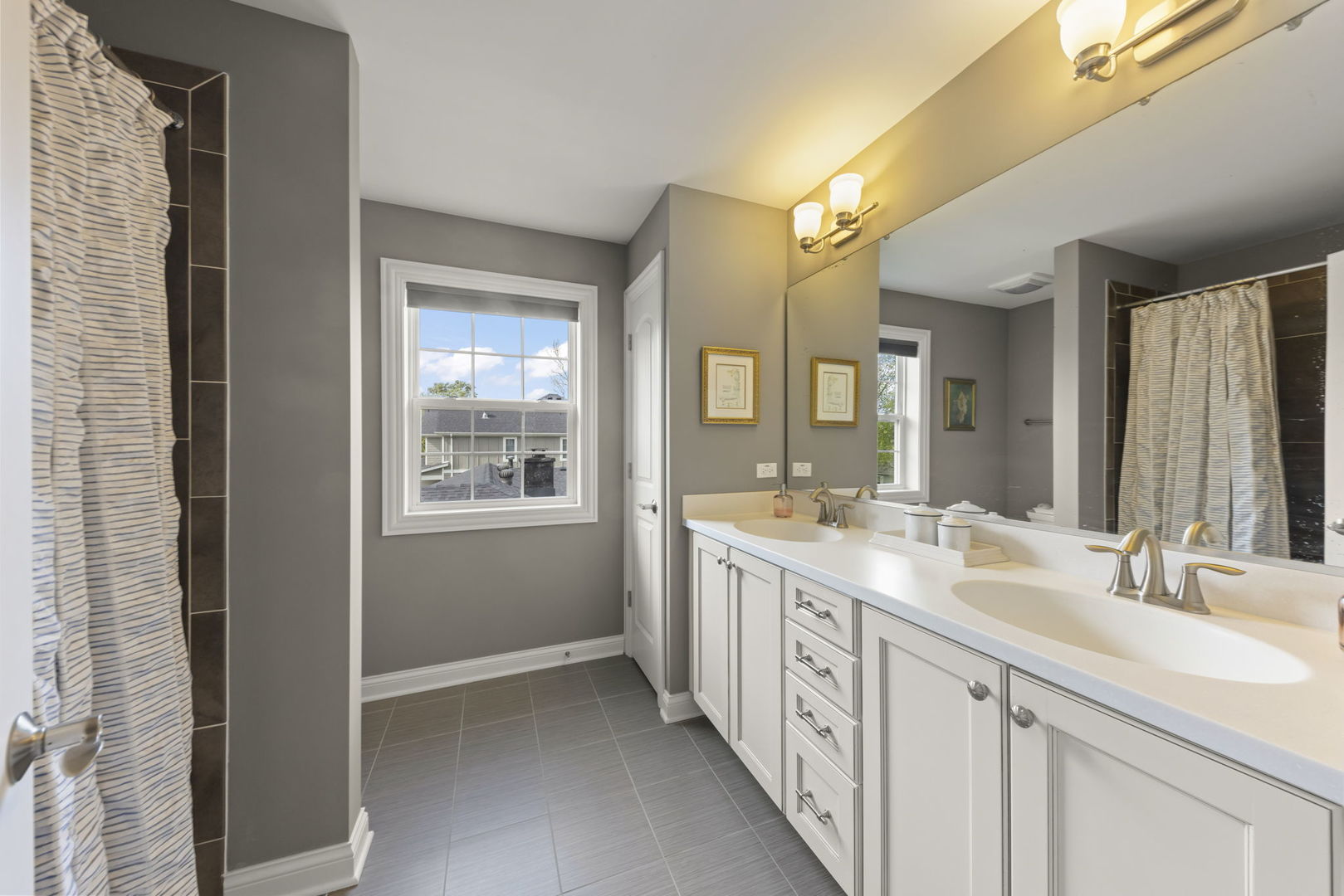 1711 Driving Park Road Wheaton, IL 60187 - Photo 24 of 41 a spacious bathroom with a double vanity sink and a mirror