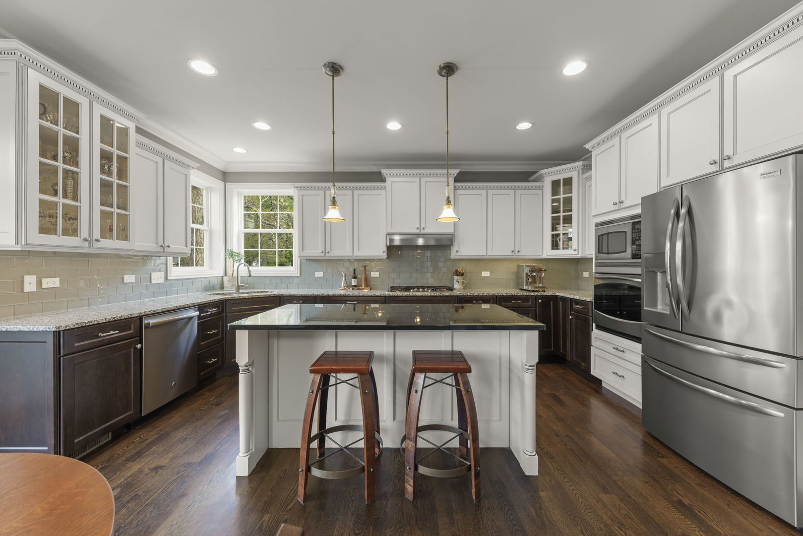 1711 Driving Park Road Wheaton, IL 60187 - Photo 8 of 41 a kitchen with kitchen island granite countertop wooden floors appliances and cabinets