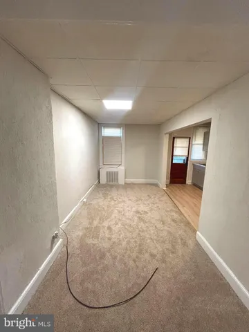 an empty room with a fireplace and painted walls