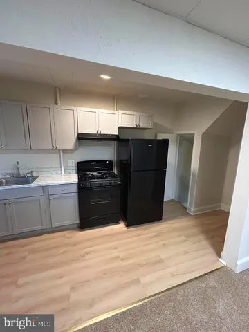 a kitchen with a cabinets and a stove top oven