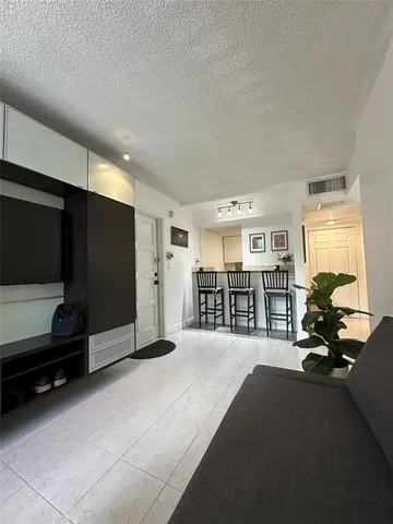 a living room with furniture and large window