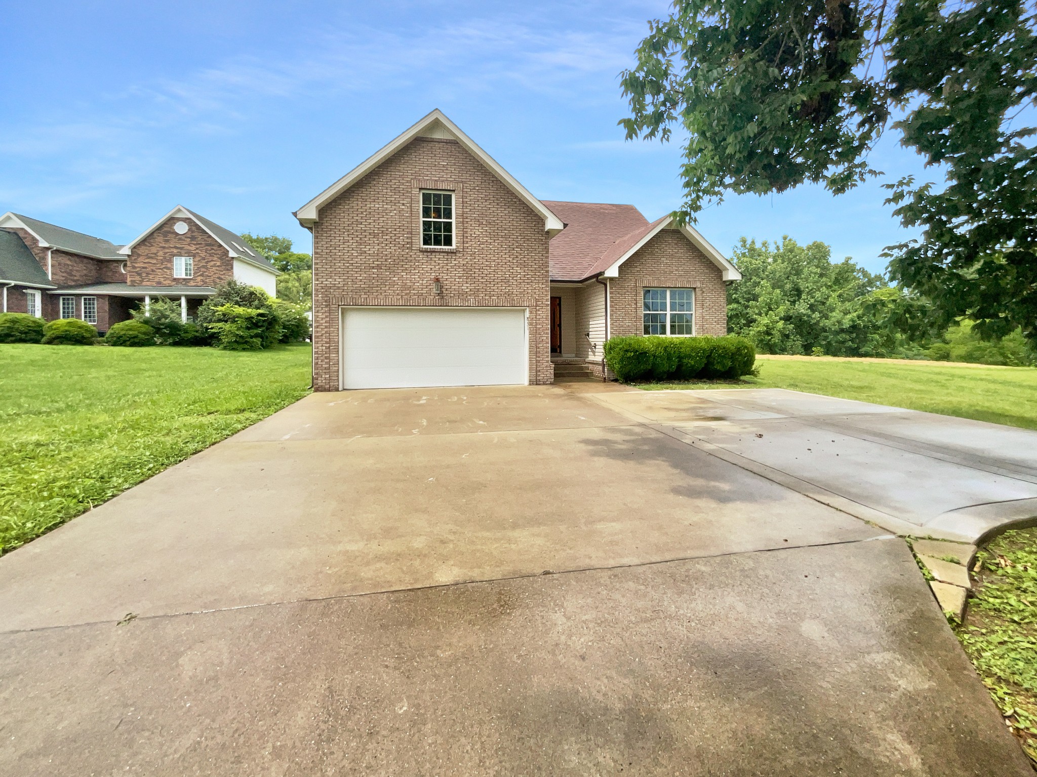 a front view of house with yard and green space