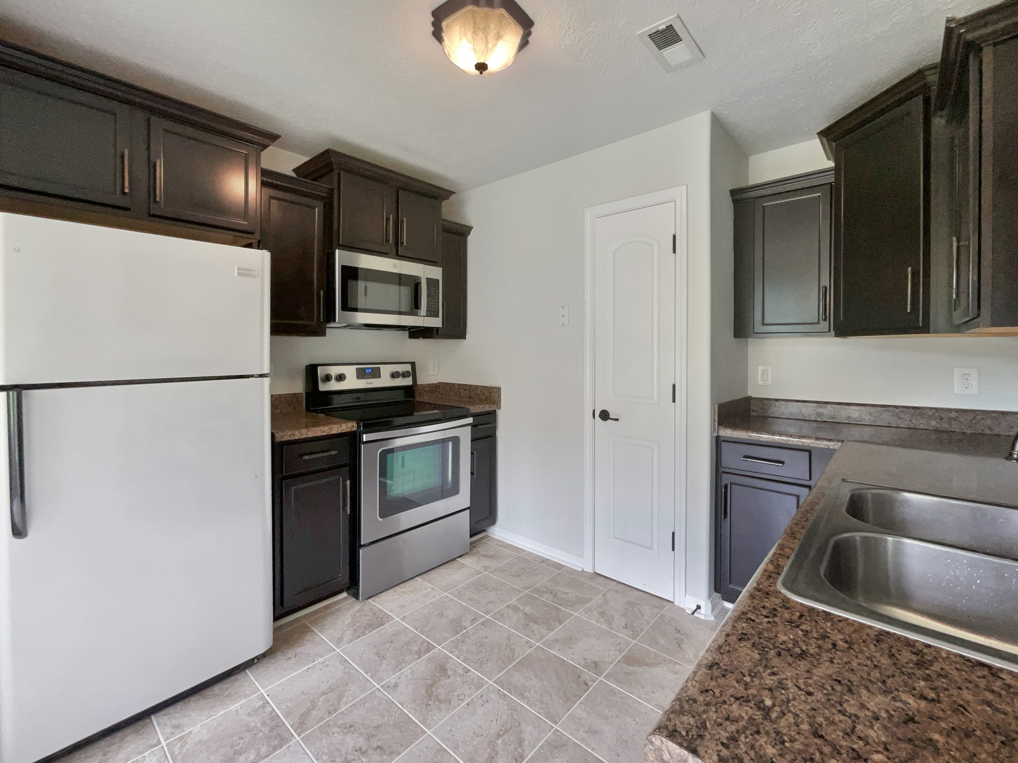 851 Salem Road Clarksville, TN 37040 - Photo 6 of 21 a kitchen with granite countertop a refrigerator and a stove top oven