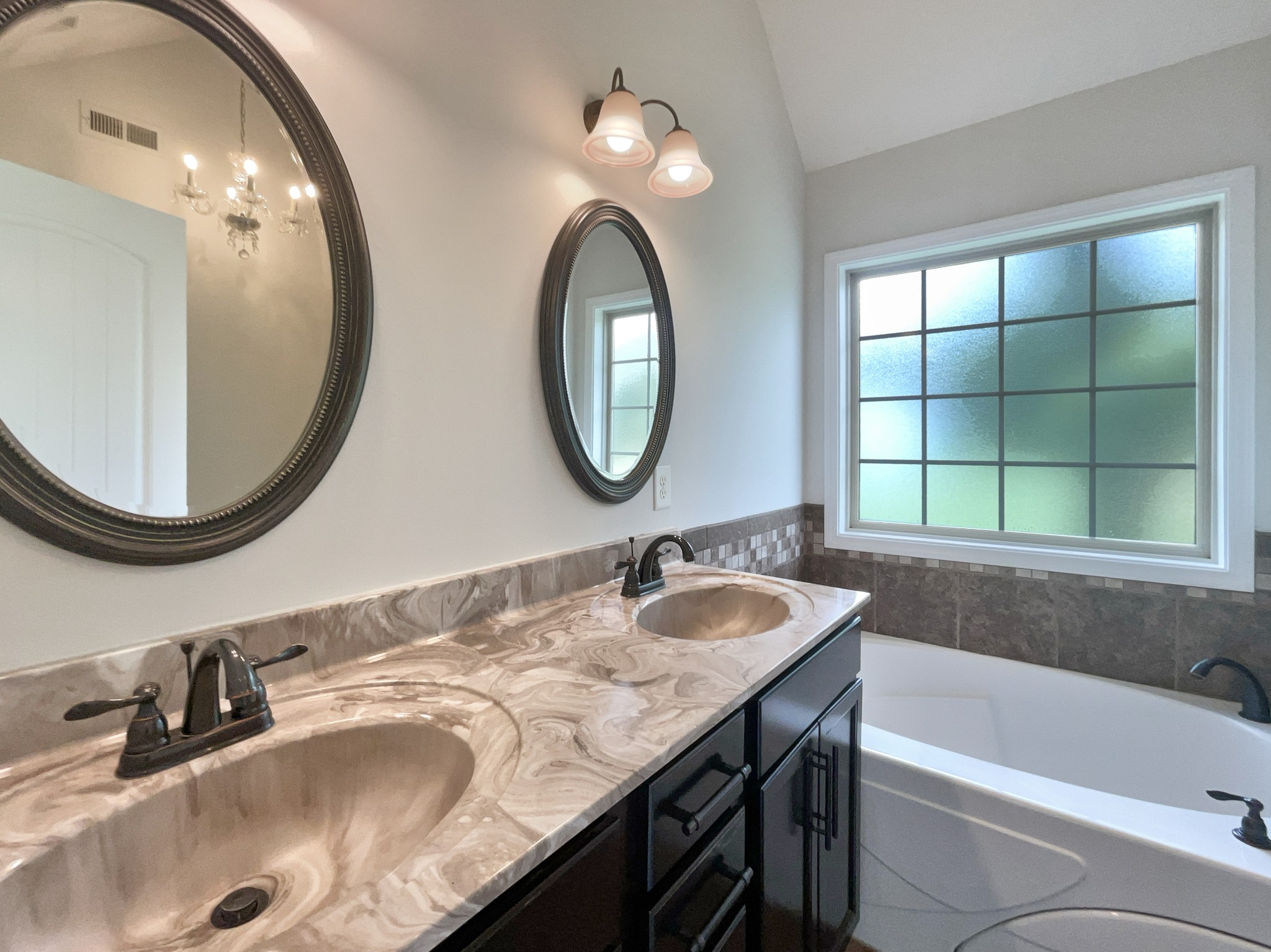 851 Salem Road Clarksville, TN 37040 - Photo 10 of 21 a bathroom with a granite countertop tub a double vanity sink and a mirror
