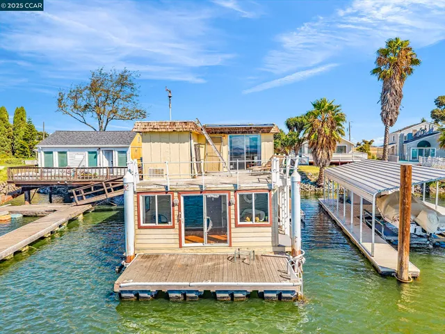 a view of a house with swimming pool and sitting area