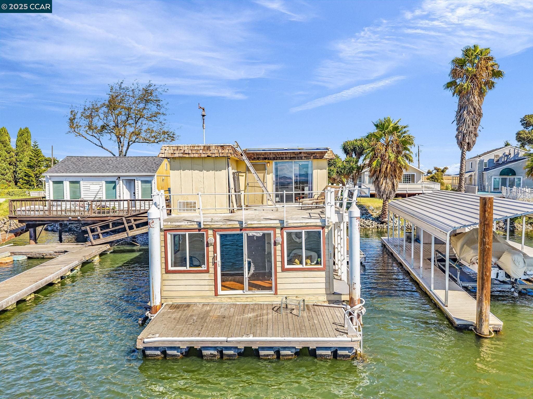 a view of a house with swimming pool and sitting area