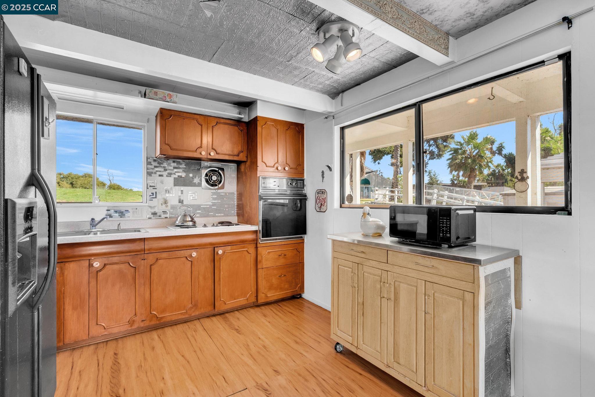 1818 Taylor Road Bethel Island, CA 94511 - Photo 18 of 59 a kitchen with stainless steel appliances granite countertop a stove and a wooden floors