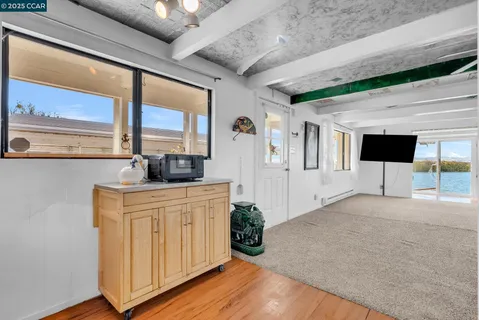 a view of a balcony with wooden floor and iron stairs