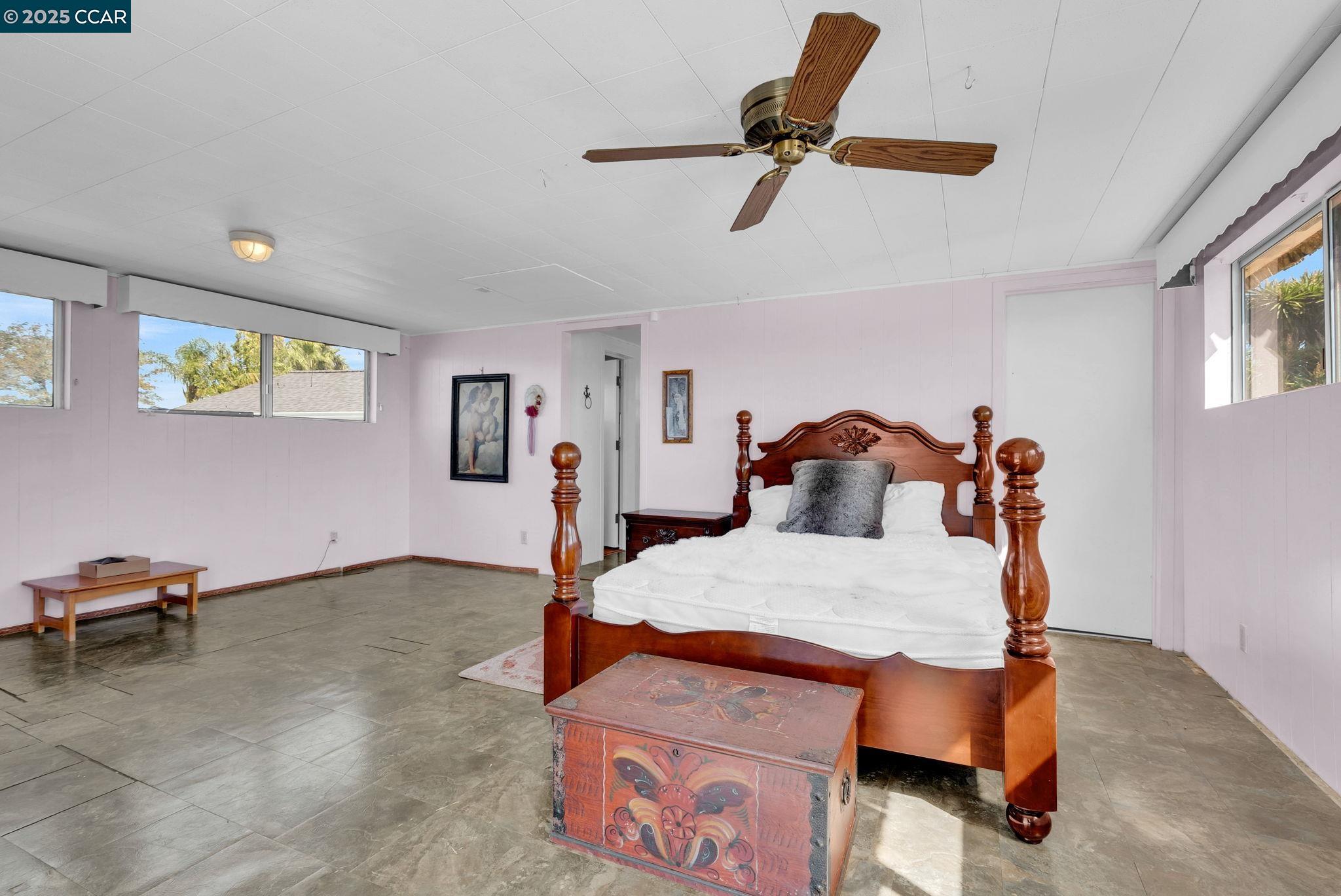 1818 Taylor Road Bethel Island, CA 94511 - Photo 33 of 59 a bedroom with a bed and a chandelier