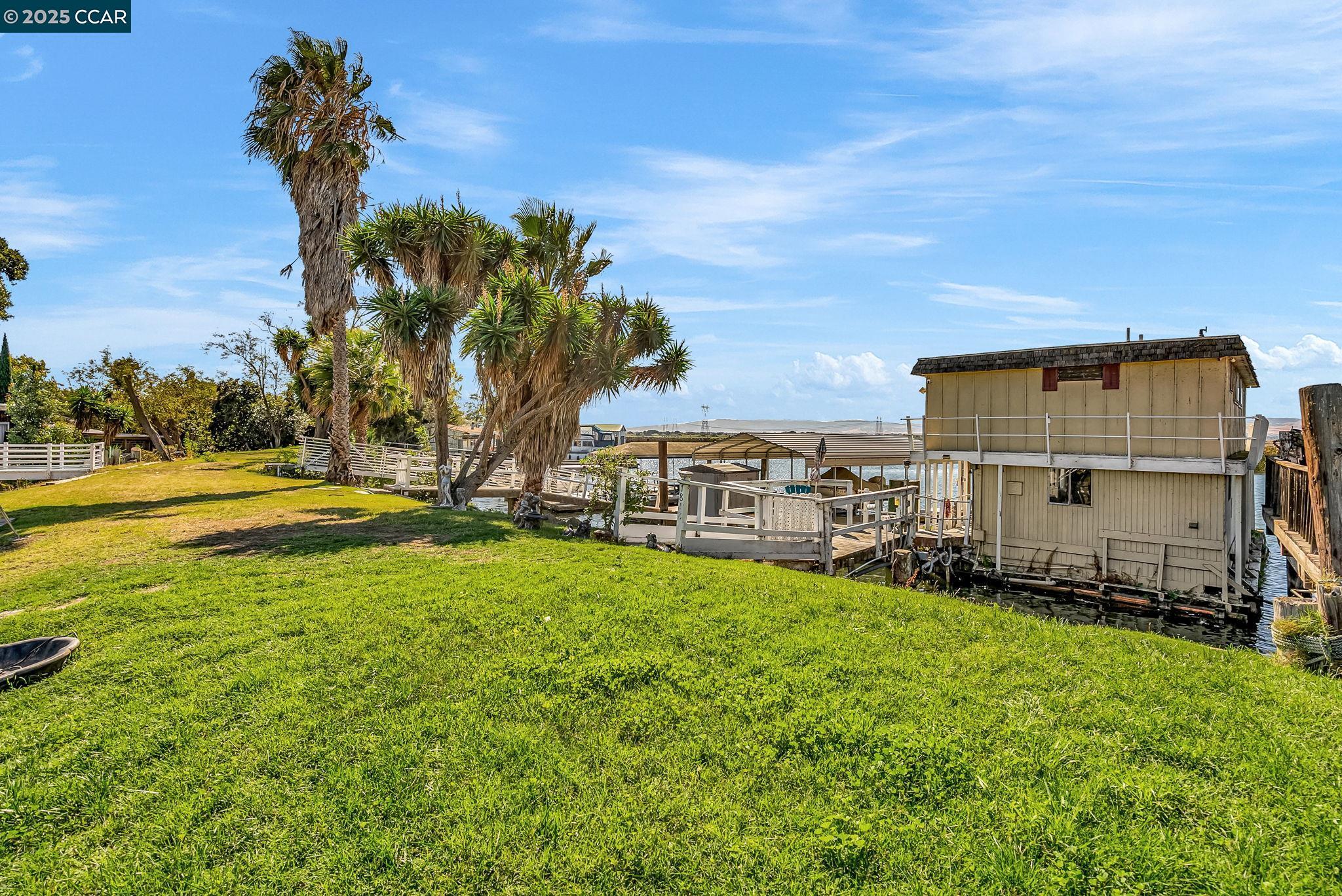 1818 Taylor Road Bethel Island, CA 94511 - Photo 8 of 59 a view of a house with a big yard and large trees