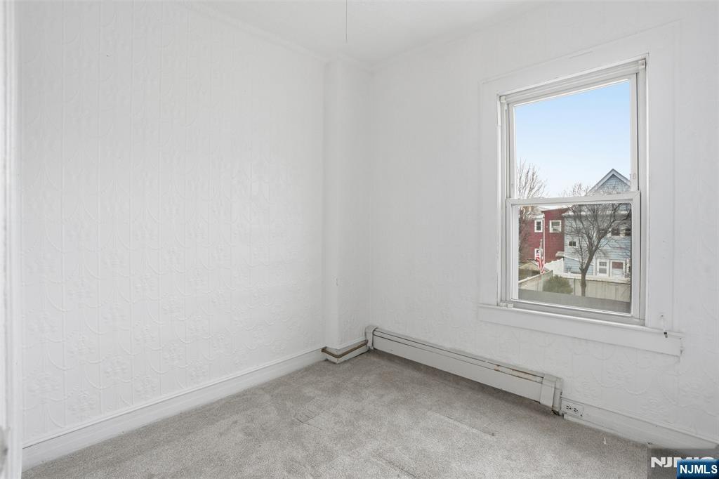 209 Hamilton Street Harrison, NJ 07029 - Photo 12 of 26 an empty room with a window