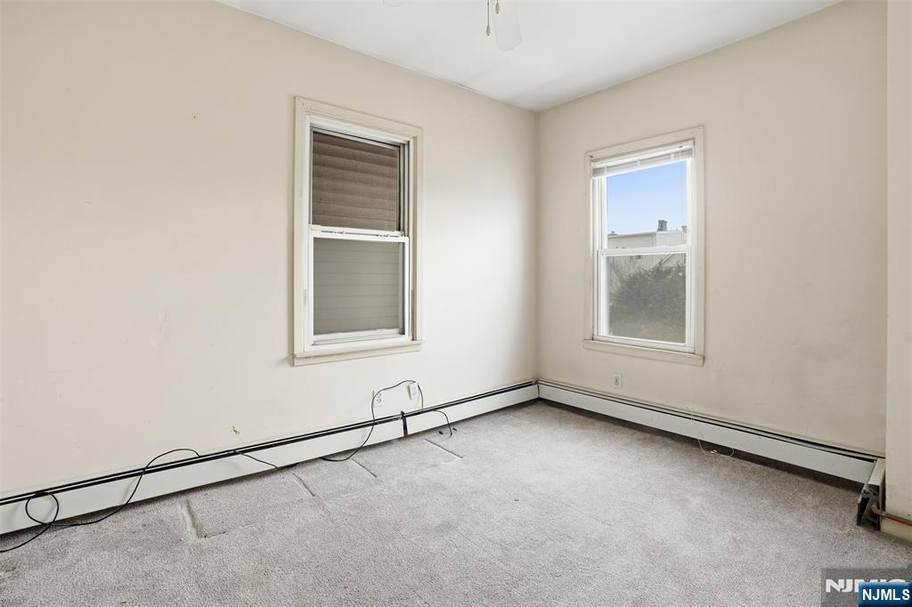 209 Hamilton Street Harrison, NJ 07029 - Photo 13 of 26 an empty room with windows