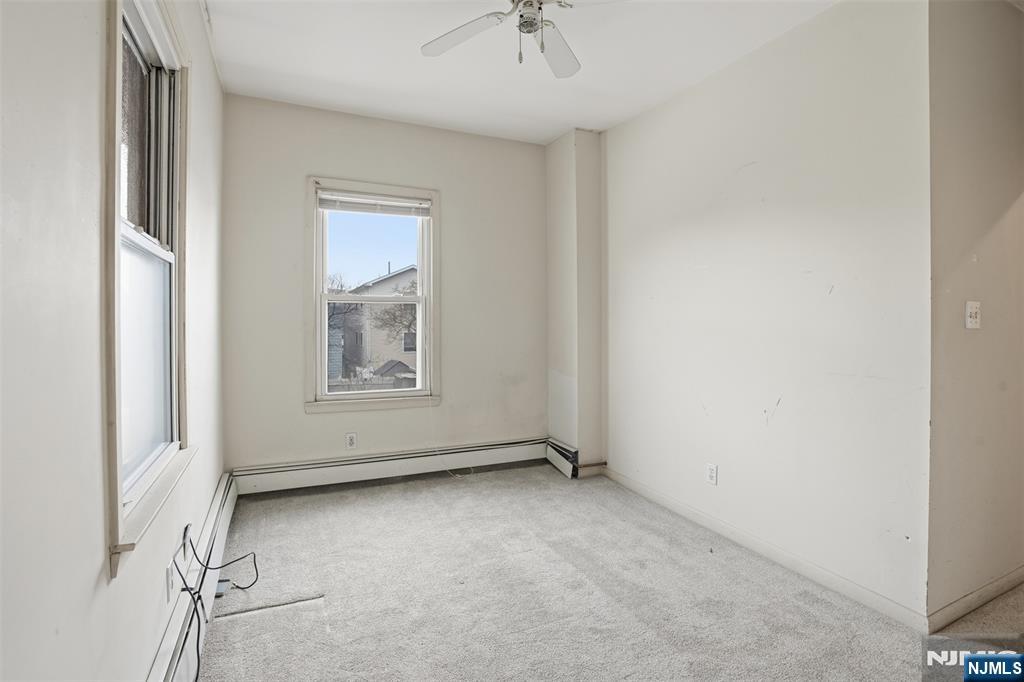 209 Hamilton Street Harrison, NJ 07029 - Photo 14 of 26 an empty room with a window and a ceiling fan