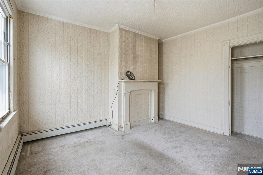 209 Hamilton Street Harrison, NJ 07029 - Photo 18 of 26 an empty room with windows