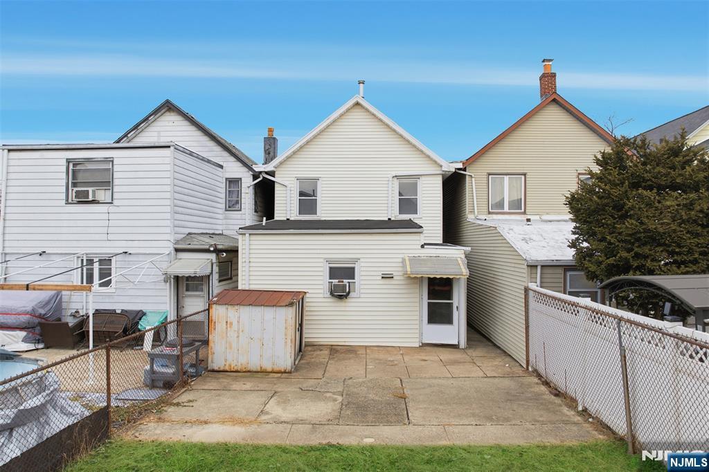 209 Hamilton Street Harrison, NJ 07029 - Photo 22 of 26 a view of a house with a yard and garage