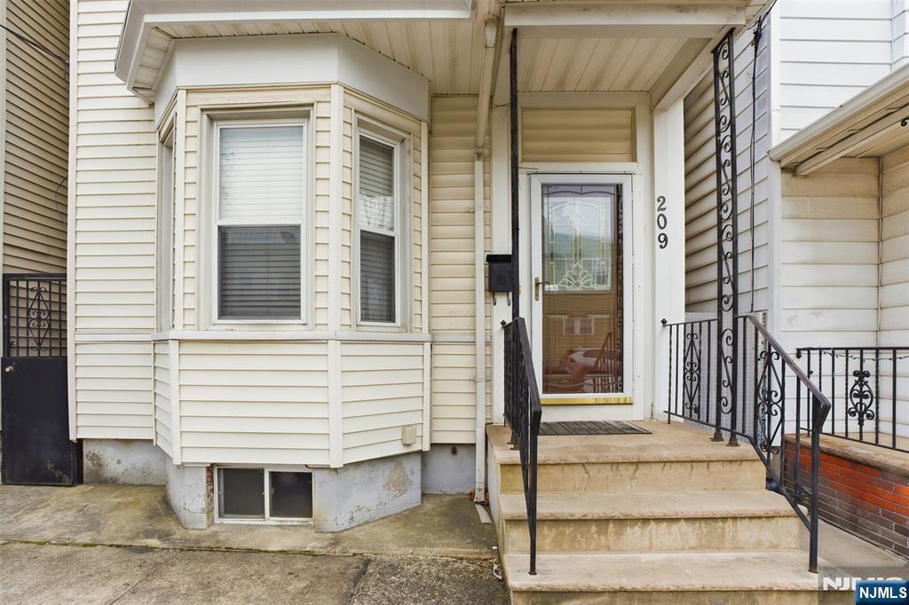 209 Hamilton Street Harrison, NJ 07029 - Photo 4 of 26 a view of a house with a door and a window