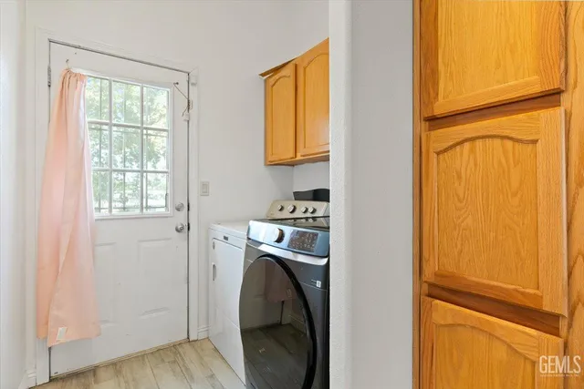 a utility room with window dryer and washer