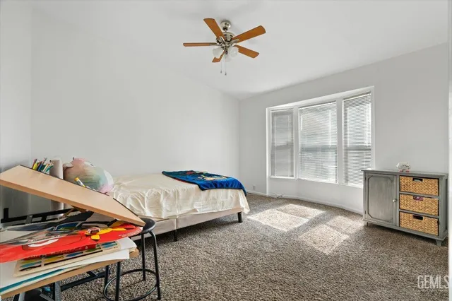 a bedroom with furniture and a window