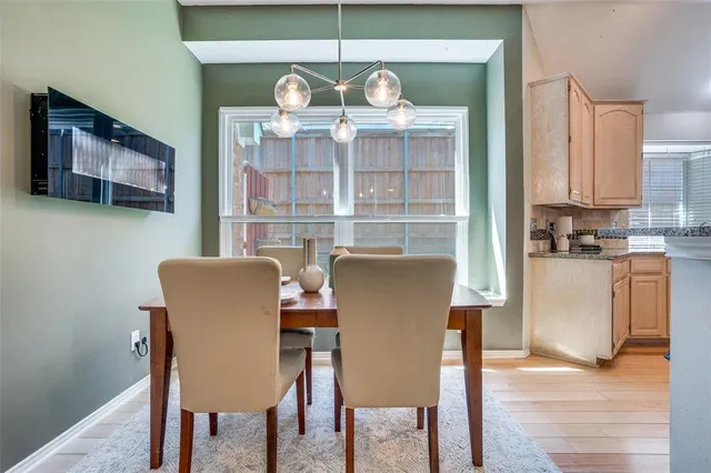 a dining room with furniture a chandelier and wooden floor