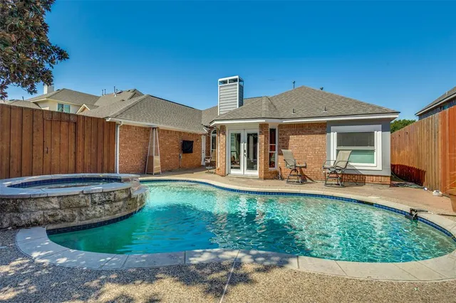 a front view of a house with swimming pool having outdoor seating