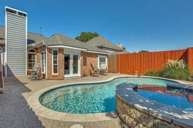 swimming pool view with a seating space