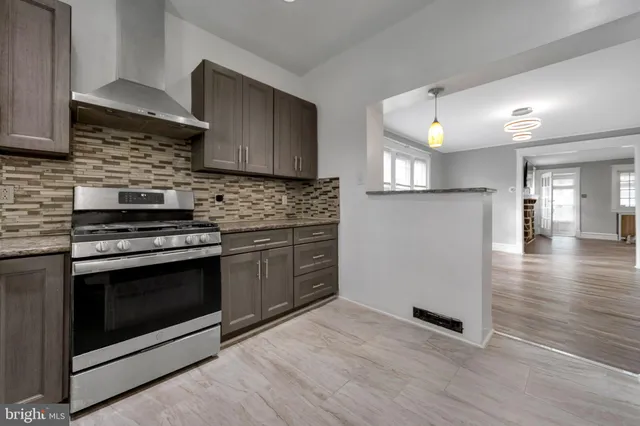 a kitchen with granite countertop a stove and a refrigerator