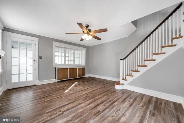wooden floor in an empty room with a window and wooden floor