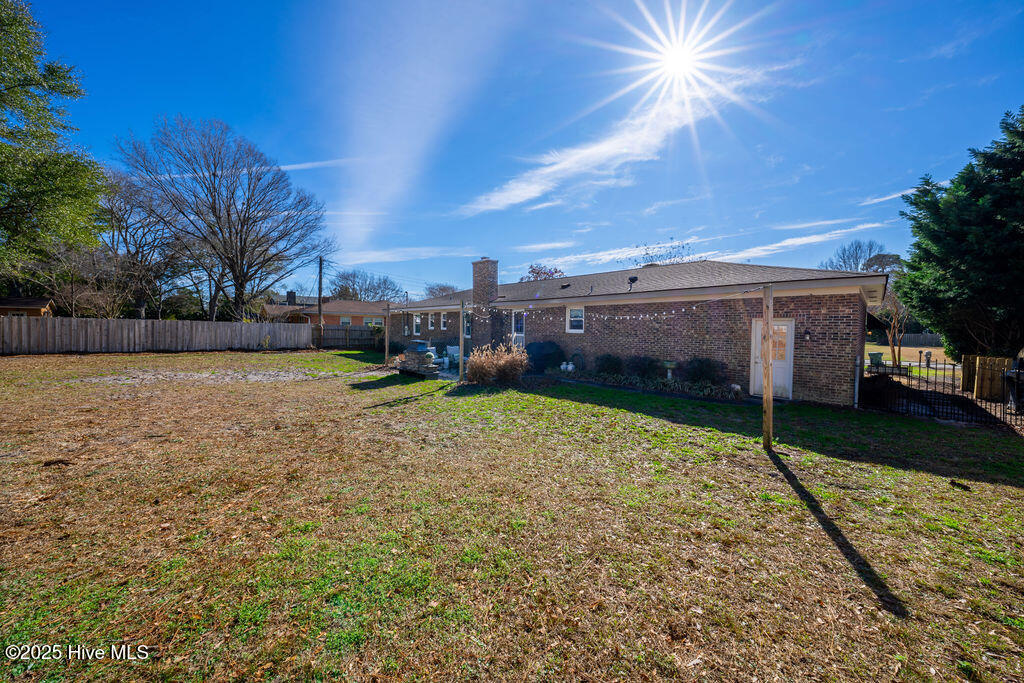 409 Windemere Road Wilmington, NC 28405 - Photo 43 of 54 Left rear yard looking back towards the garage and outdoor living space