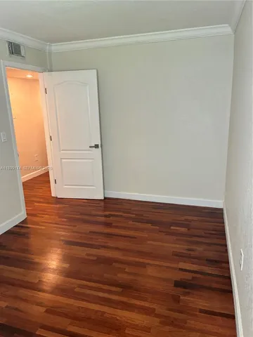 a view of room with wooden floor