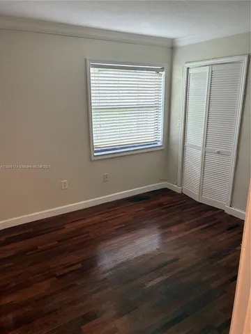 a view of a room with wooden floor and windows