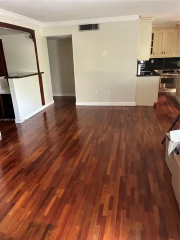 a view of a kitchen with wooden floor and a sink
