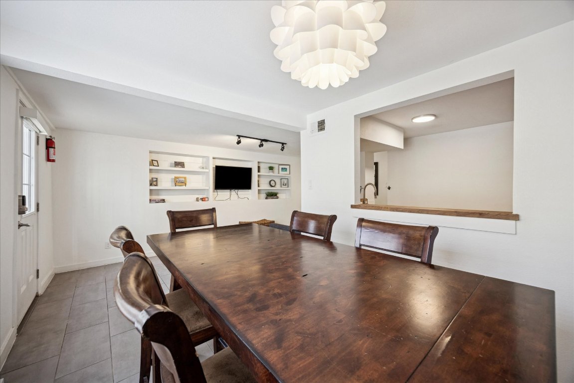 604 Pressler Street Austin, TX 78703 - Photo 27 of 40 Dining space featuring track lighting and dark tile patterned flooring