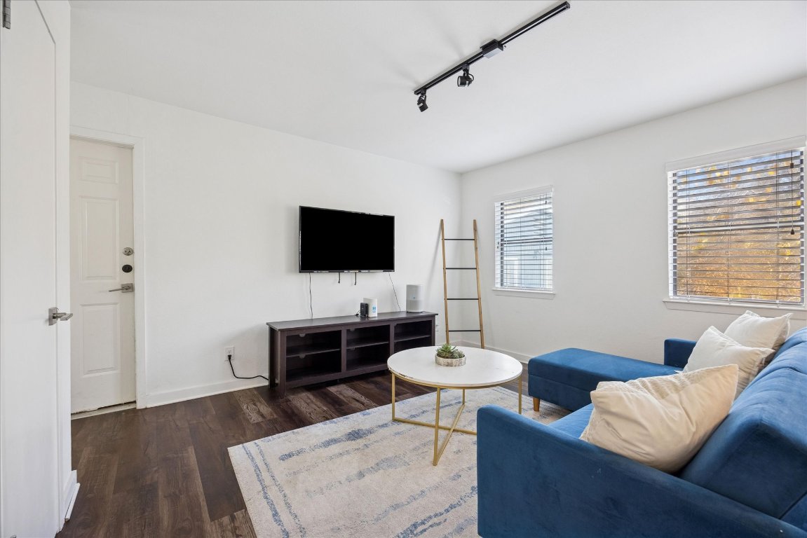 604 Pressler Street Austin, TX 78703 - Photo 34 of 40 Living room featuring rail lighting and dark wood-style floors