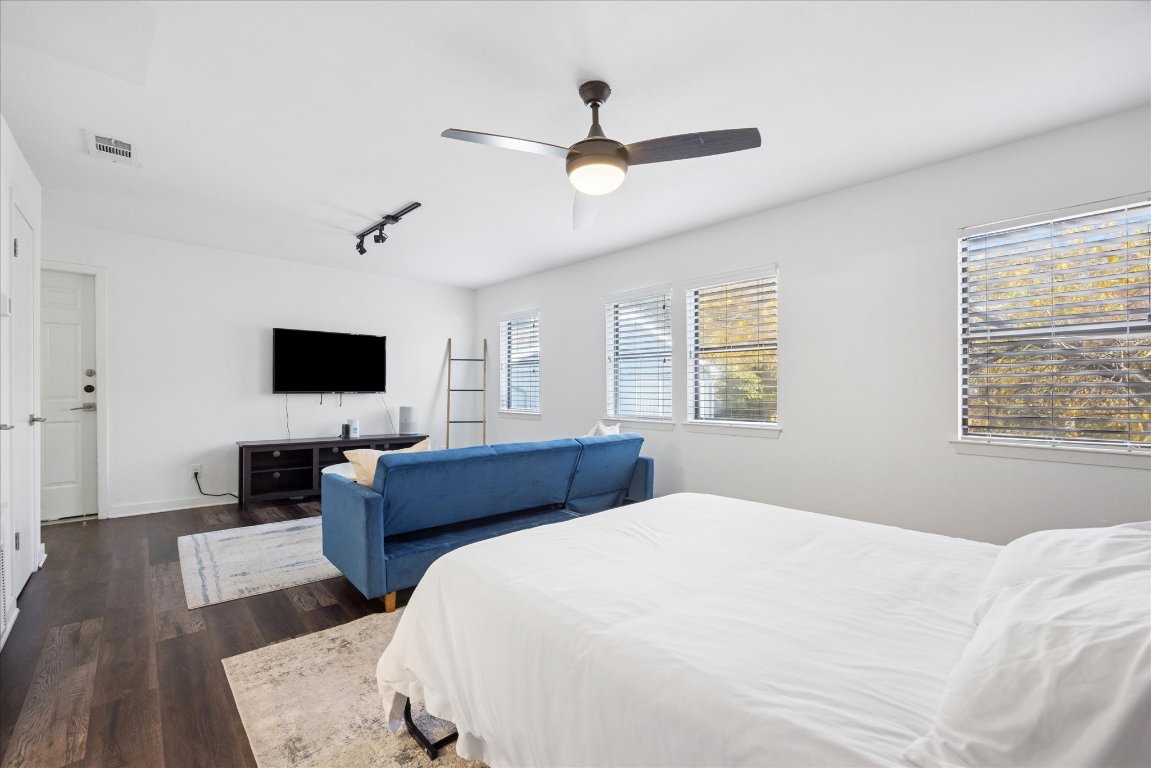 604 Pressler Street Austin, TX 78703 - Photo 35 of 40 Bedroom with dark wood-style flooring, ceiling fan, and track lighting