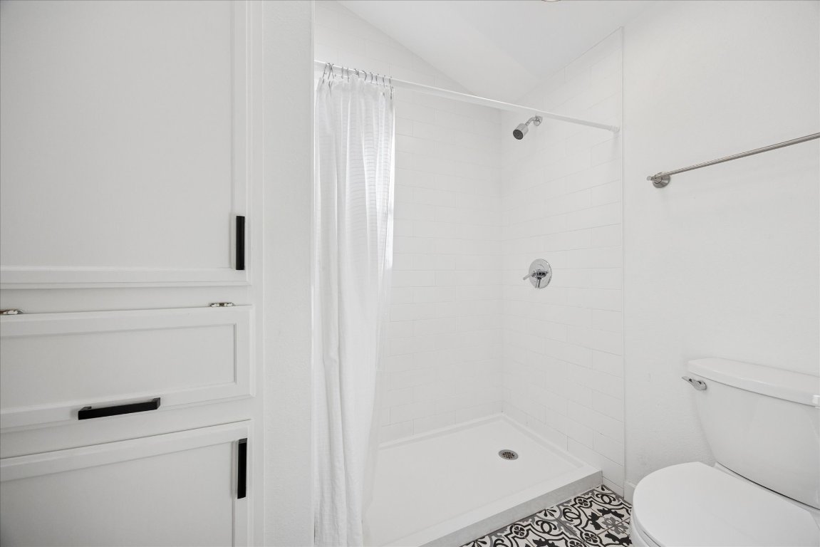 604 Pressler Street Austin, TX 78703 - Photo 37 of 40 Bathroom featuring a stall shower and lofted ceiling