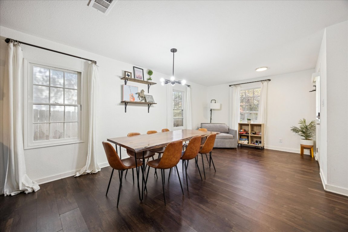 604 Pressler Street Austin, TX 78703 - Photo 4 of 40 Dining space featuring dark wood-style flooring and a chandelier
