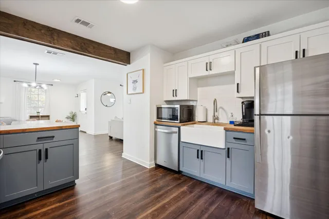 a kitchen with a refrigerator sink and cabinets