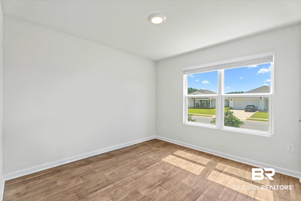23641 Unbridled Loop Daphne, AL 36526 - Photo 24 of 40 White interior walls featuring wood-finish flooring