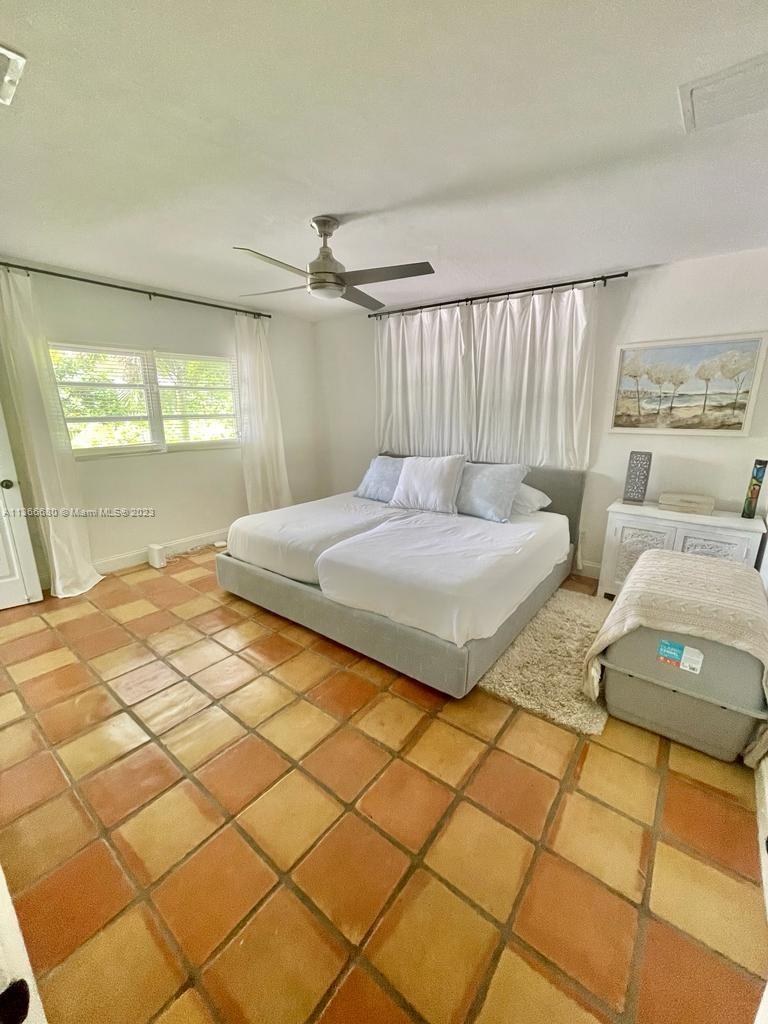 Pinecrest Pinecrest, FL 33156 - Photo 17 of 25 a bedroom with a bed and a night stand