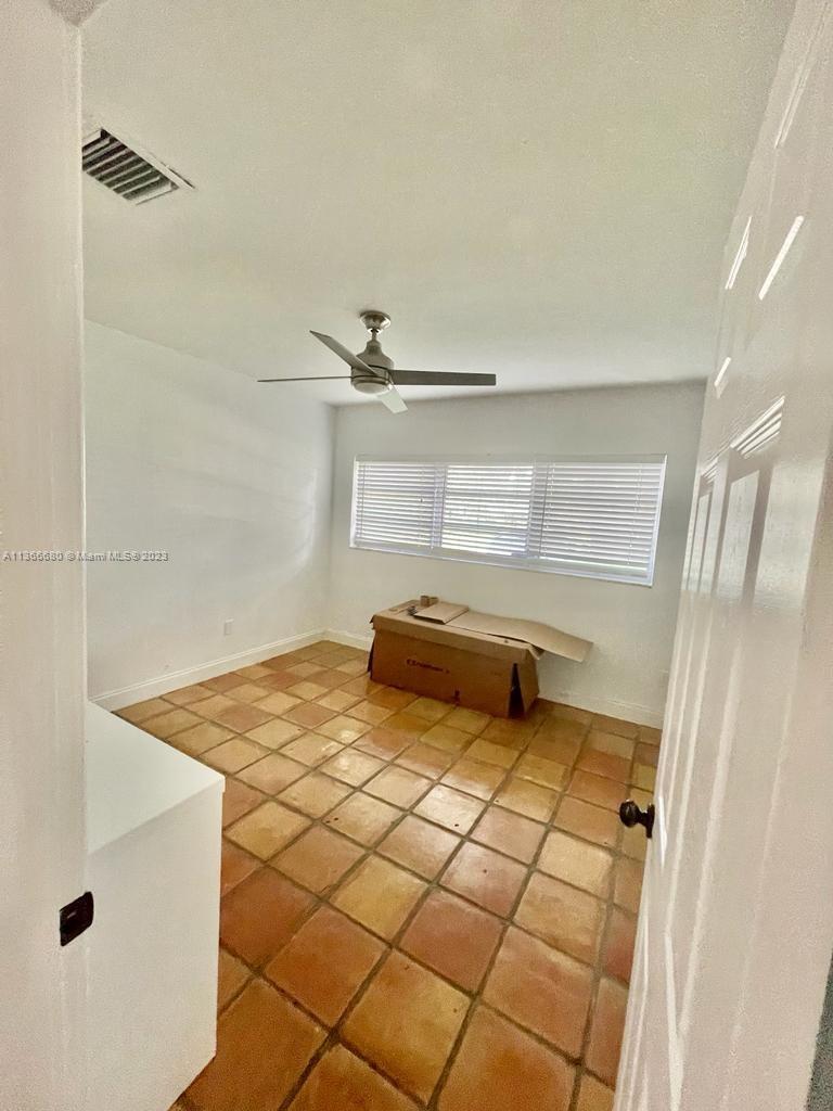 Pinecrest Pinecrest, FL 33156 - Photo 18 of 25 a view of a room with racks on the wall