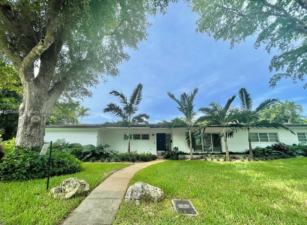 Pinecrest Pinecrest, FL 33156 - Photo 2 of 25 a front view of a house with a garden and plants