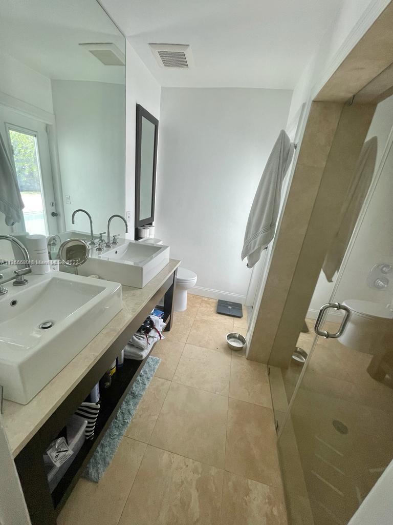 Pinecrest Pinecrest, FL 33156 - Photo 22 of 25 a bathroom with a double vanity sink and mirror