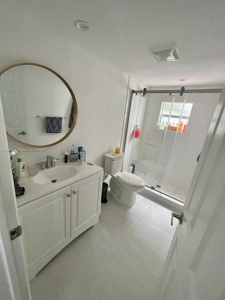 Pinecrest Pinecrest, FL 33156 - Photo 25 of 25 a bathroom with a sink and mirror with bathtub