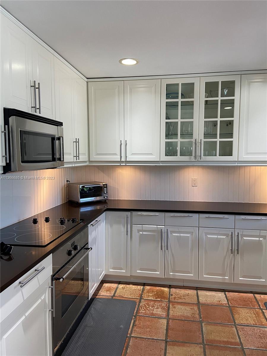 Pinecrest Pinecrest, FL 33156 - Photo 10 of 25 a kitchen with granite countertop a stove a sink and a granite counter tops