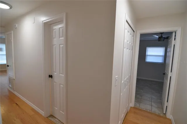 an empty room with a window and a fan