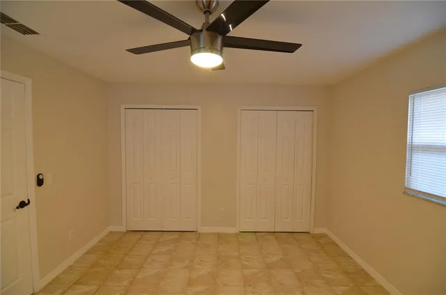 a bathroom with a granite countertop sink toilet a mirror and shower