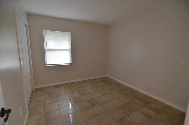 a view of an empty room and closet area
