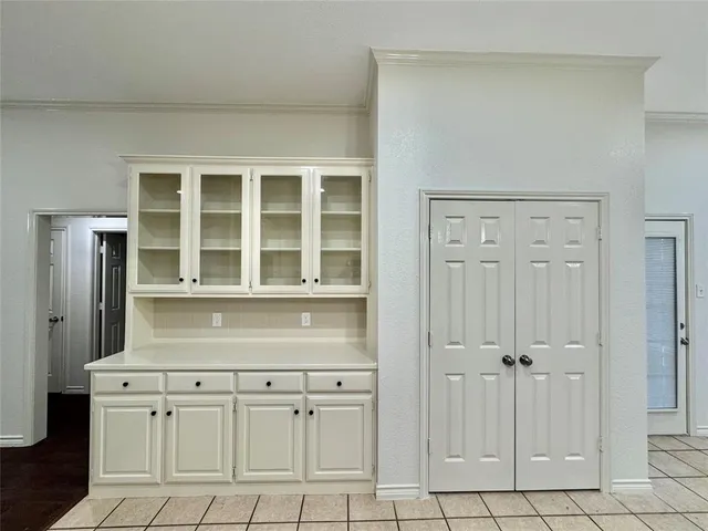 a view of a kitchen with white cabinets