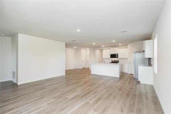 a view of kitchen with kitchen island and stainless steel appliances
