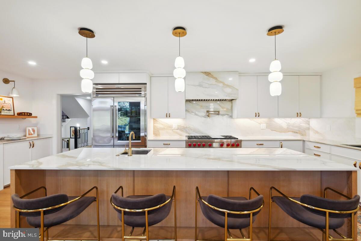 11900 Viewcrest Terrace Silver Spring, MD 20902 - Photo 13 of 69 a kitchen with stainless steel appliances a dining table and chairs in it